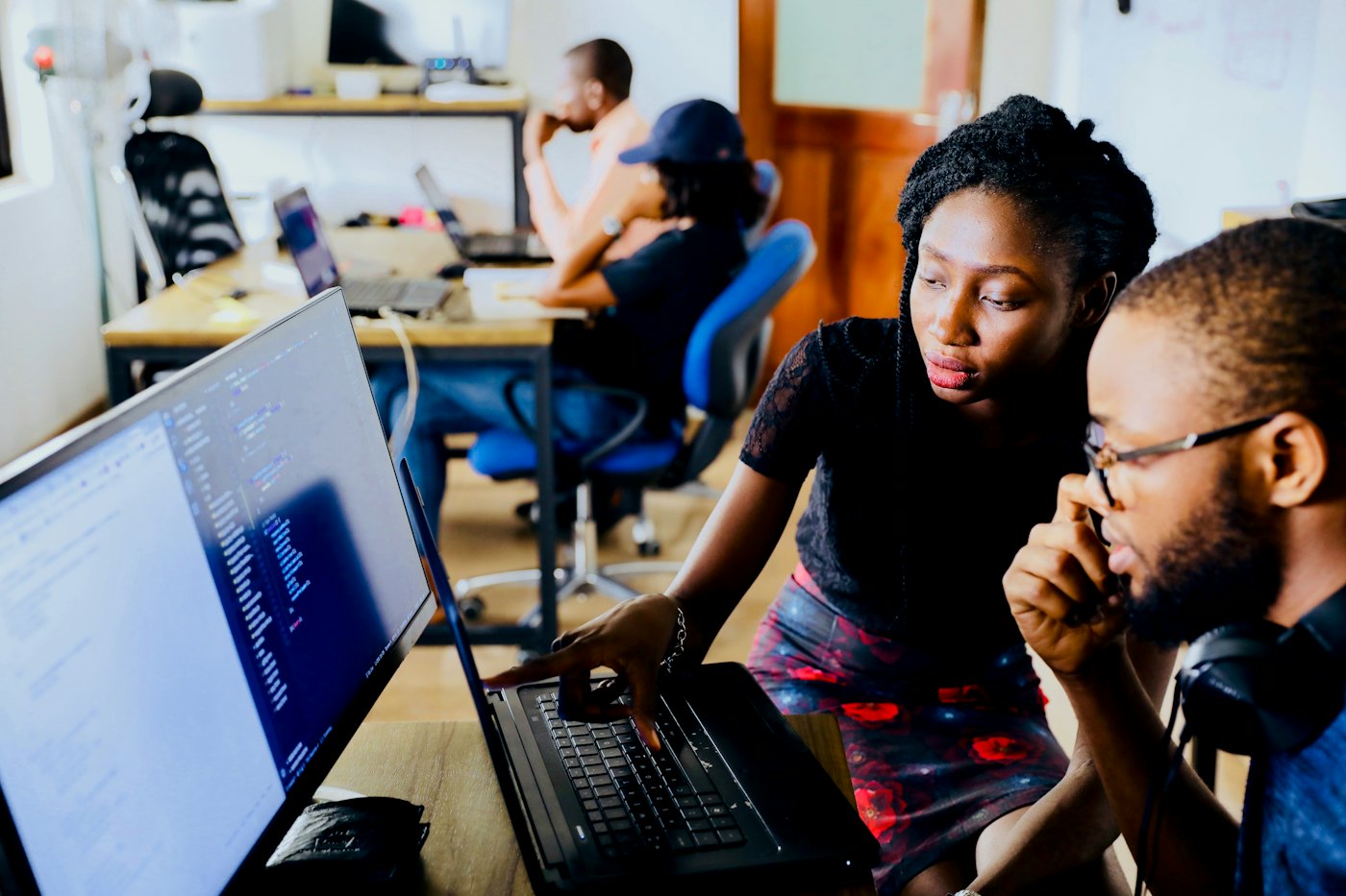 Developers reviewing code together on a laptop