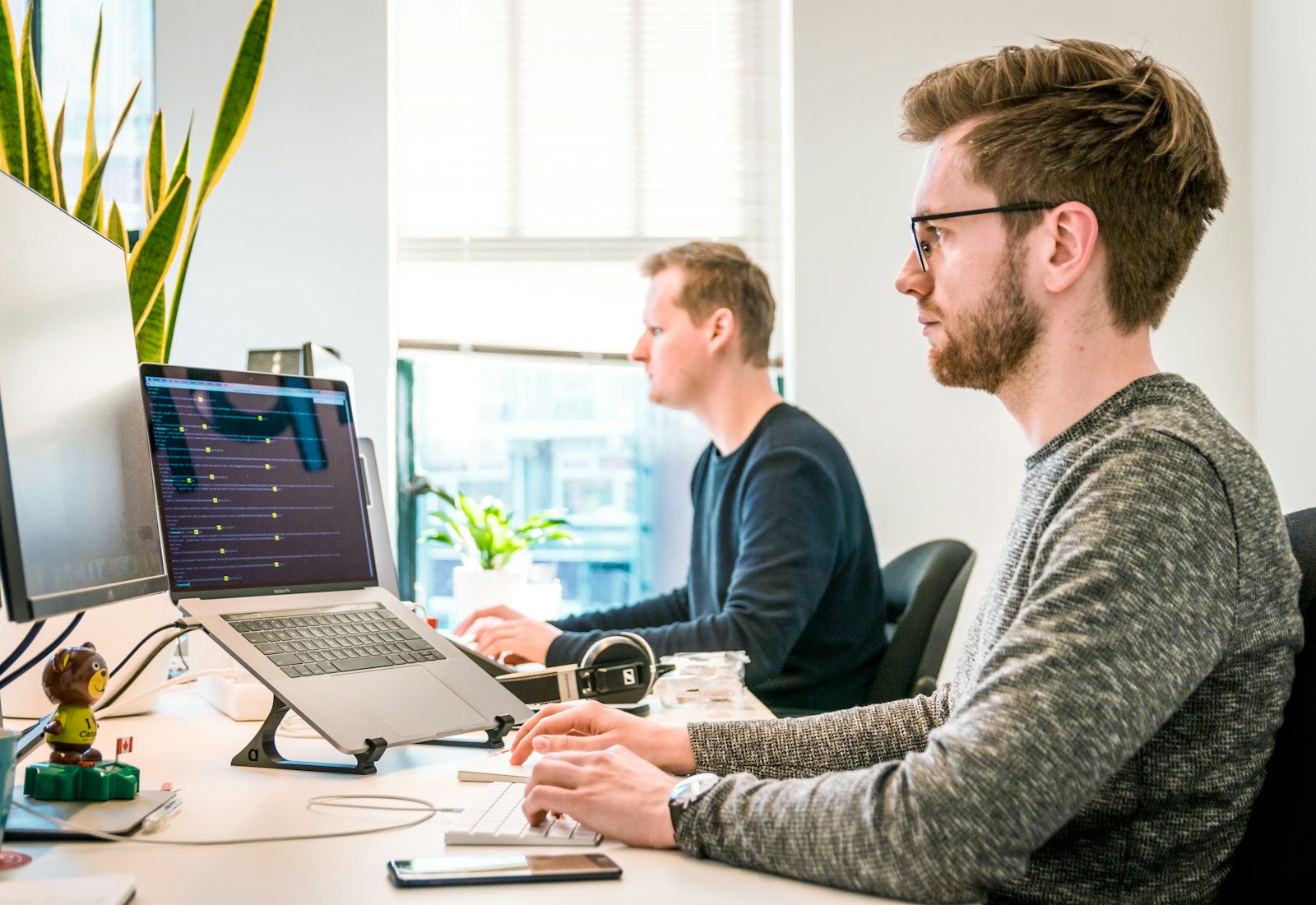 Two engineers reviewing a product's monitoring together