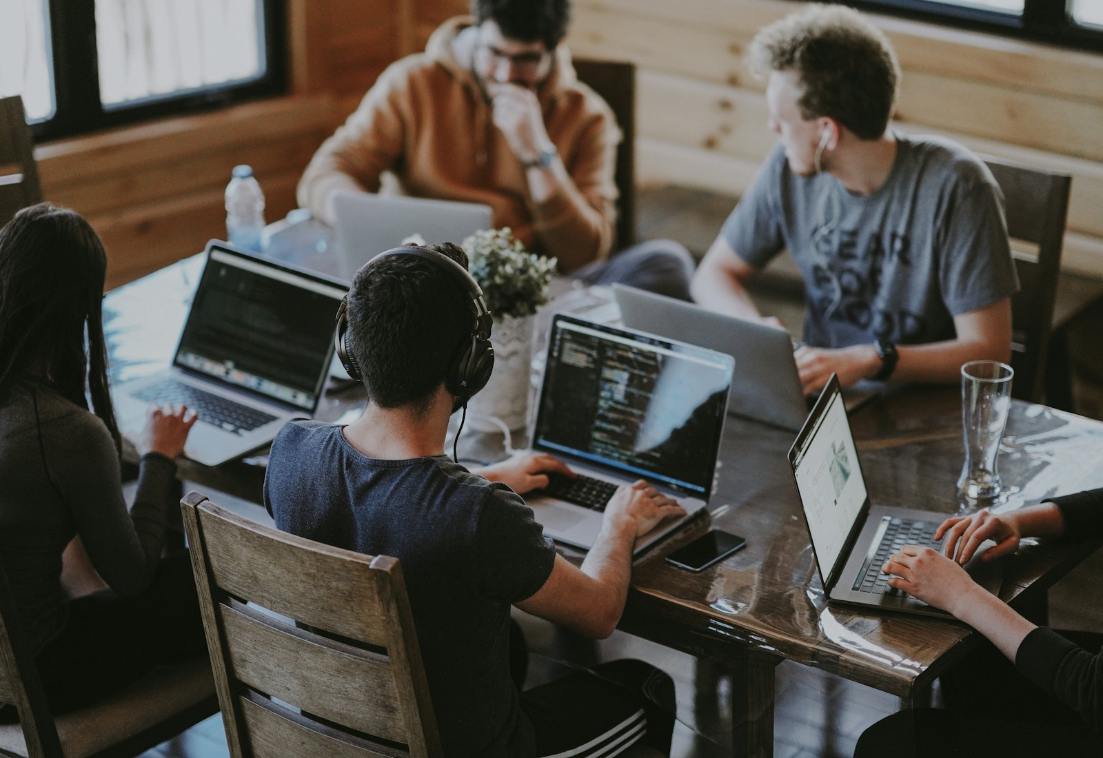 A team testing a prototype together on laptops