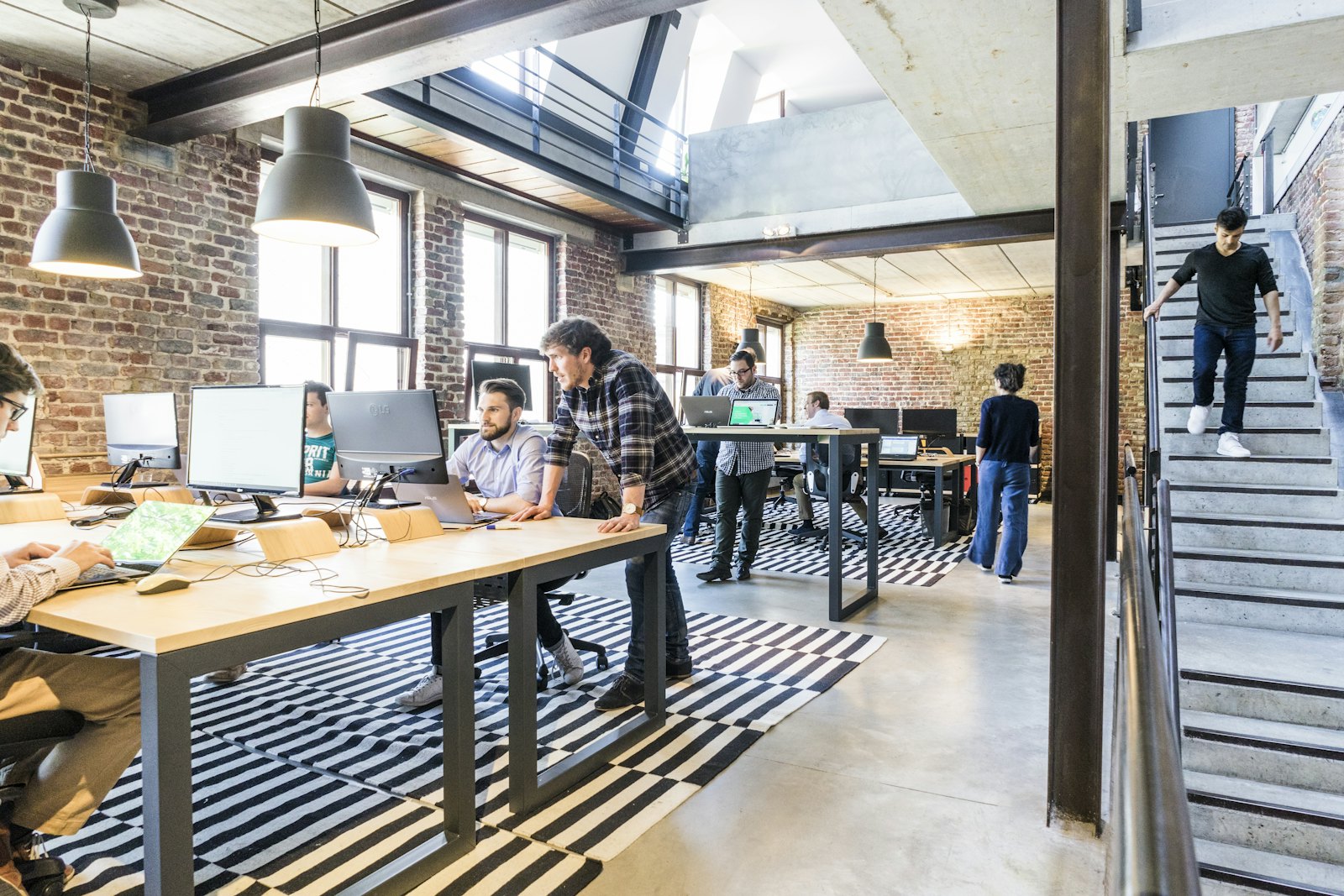 An open studio with people working at long desks
